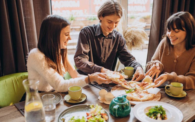 table with happy dining guests at a restaurant, UK gourmet activities, October 2024, UK