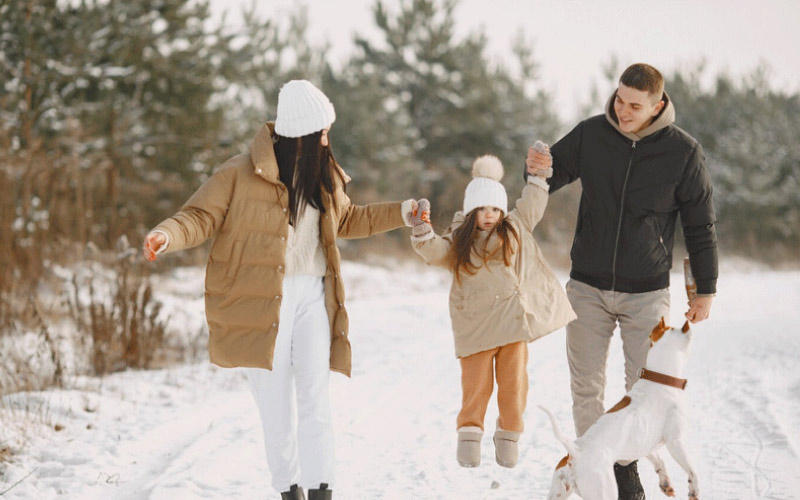 family posing for camera in winter clothes, winter tourists, November 2024, UK